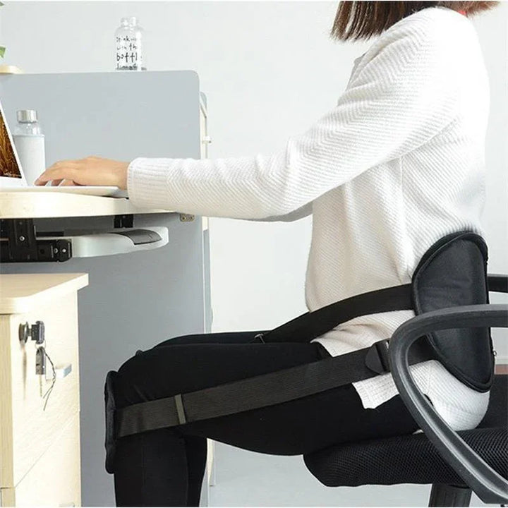 Woman using ergonomic posture corrector belt while working at desk