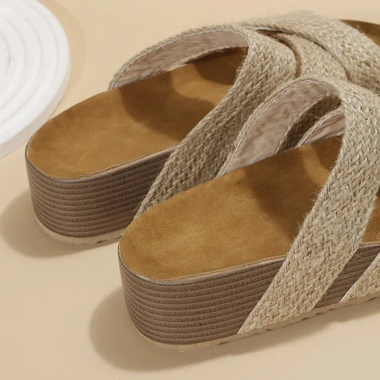Beige woven platform sandals with wide crisscross straps on a neutral background