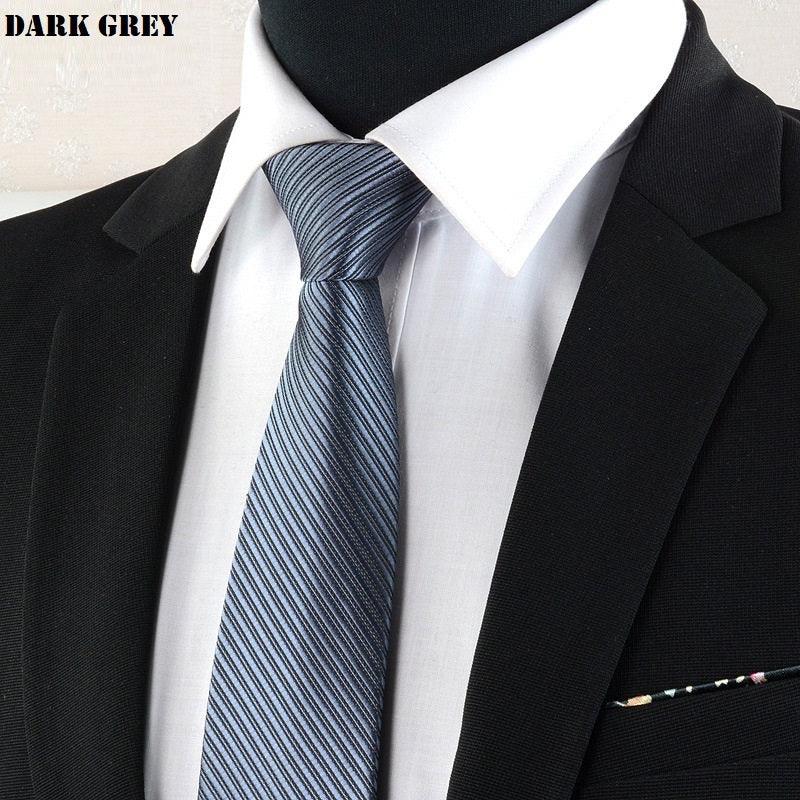 Close-up of dark grey striped necktie on white shirt with black suit jacket