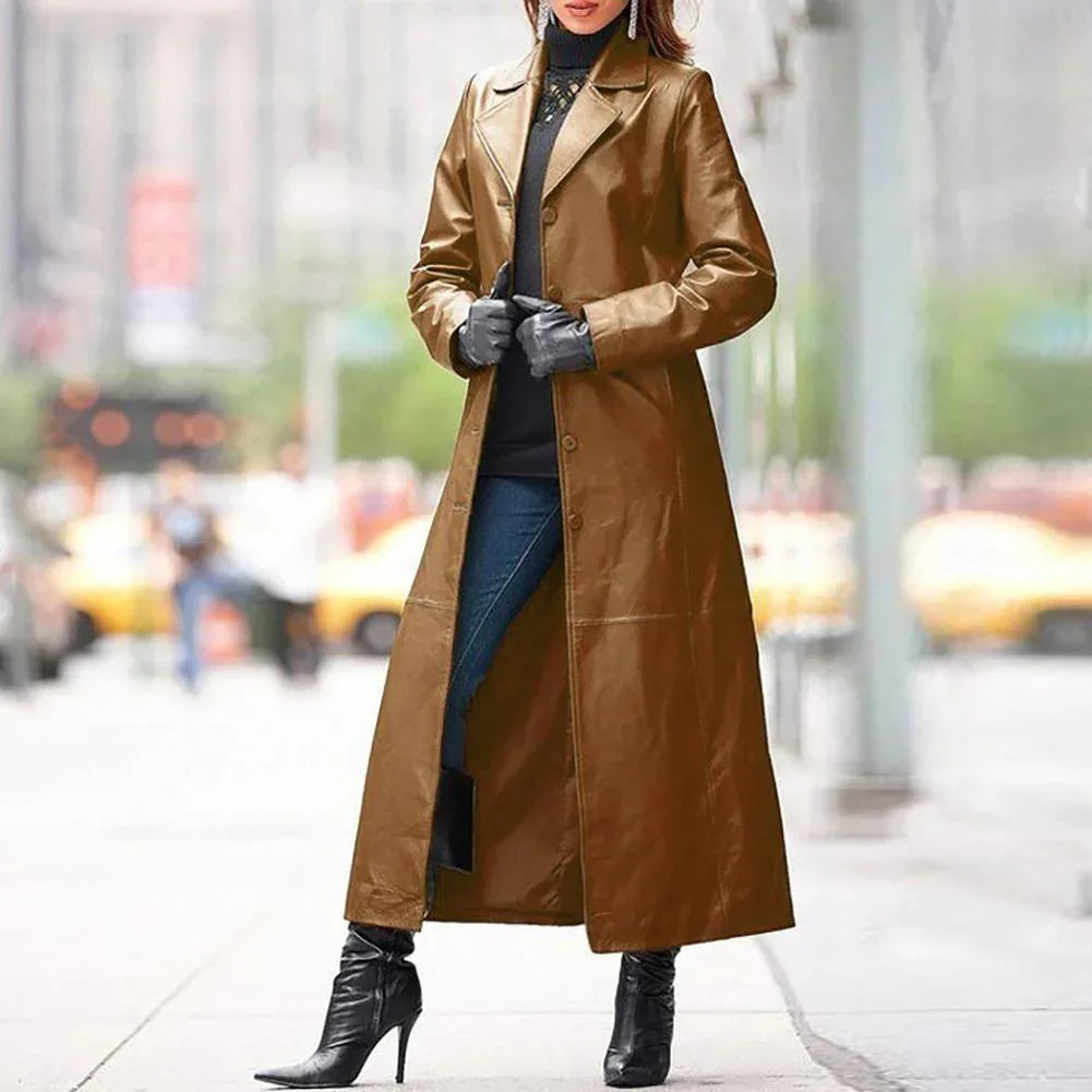 Woman wearing a long brown leather trench coat with black gloves and high-heeled boots on city street