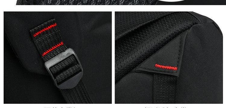 Close-up of black backpack strap with red stitching and padded shoulder support details