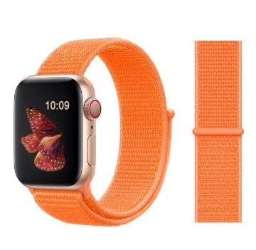 Smartwatch with a vibrant orange woven nylon band and butterfly watch face, displayed with extra band strap