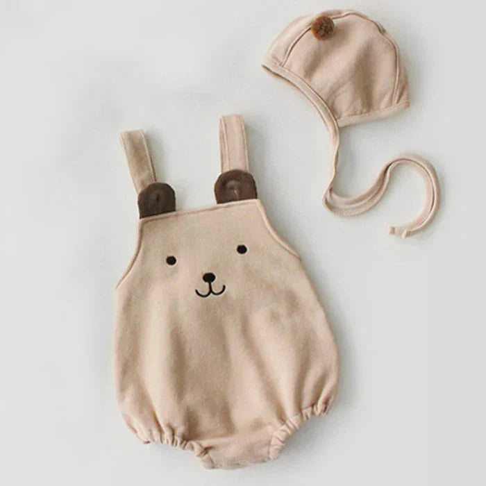 Beige baby romper with bear face and ears design, paired with matching bonnet hat with pompom