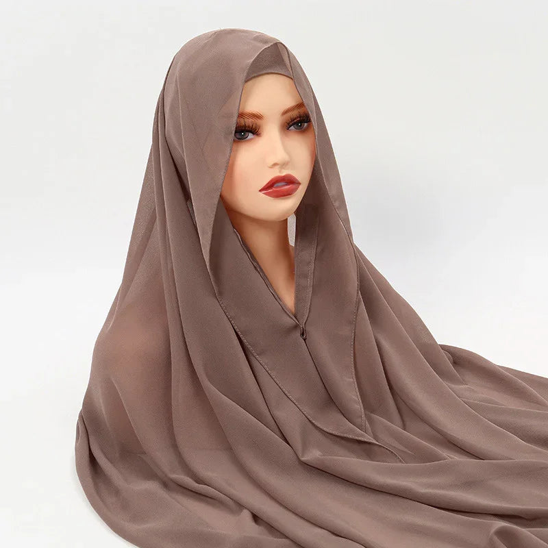  mannequin wearing mauve brown chiffon hijab against white background