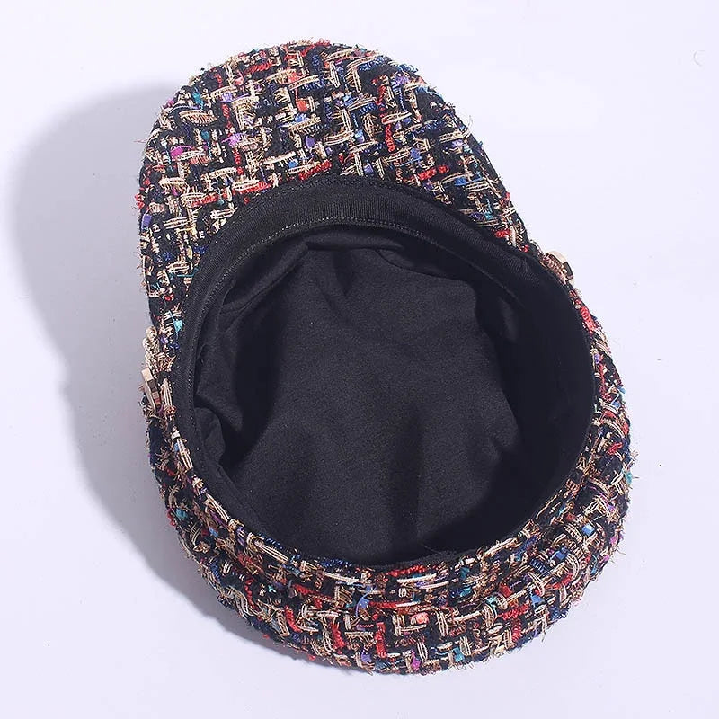 colorful tweed newsboy cap with black inner lining on white background