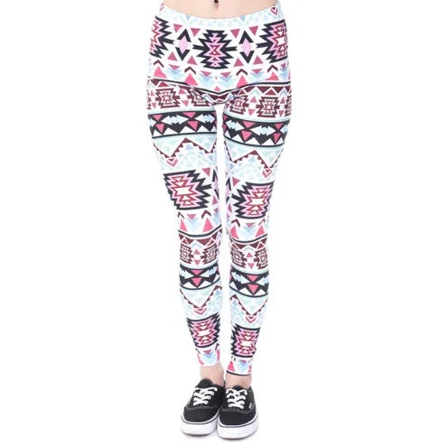 Woman wearing white leggings with colorful Aztec geometric patterns and black casual sneakers