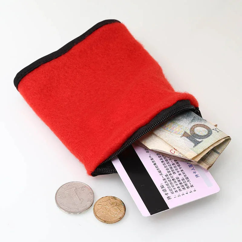 Red felt zippered coin pouch with cash, coins and a card on white background