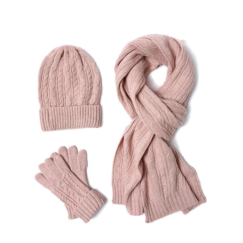Pink knitted winter set with hat, scarf, and gloves featuring cable knit pattern