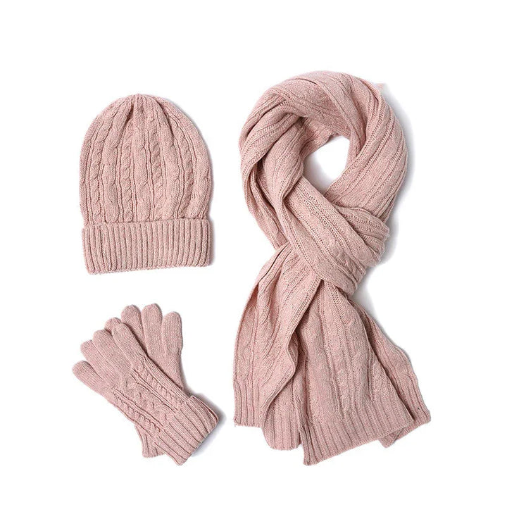 Pink knitted winter set with hat, scarf, and gloves featuring cable knit pattern