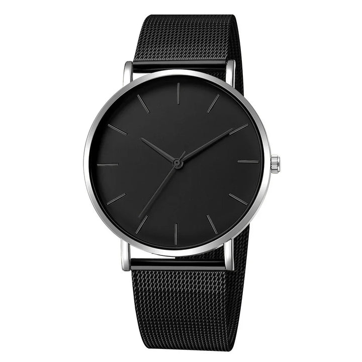 Minimalist black wristwatch with silver case and mesh strap on white background
