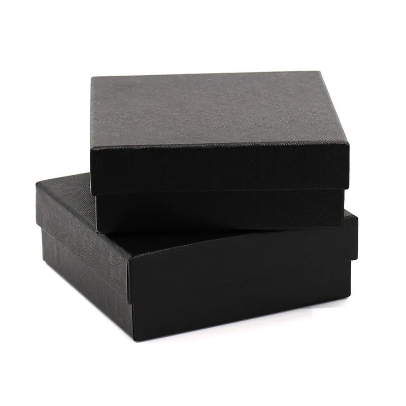Two black textured gift boxes stacked on white background, one smaller on top of larger