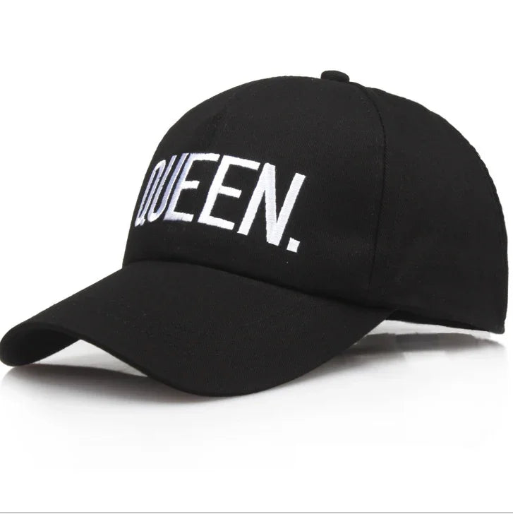 Black baseball cap with white embroidered text 'QUEEN.' on front panel