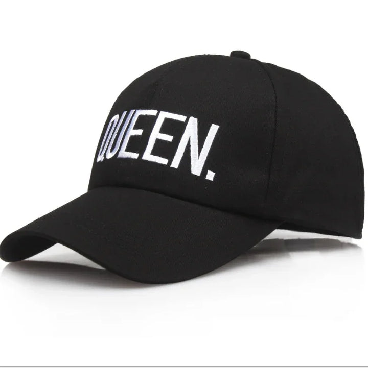 Black baseball cap with white embroidered text 'QUEEN.' on front panel