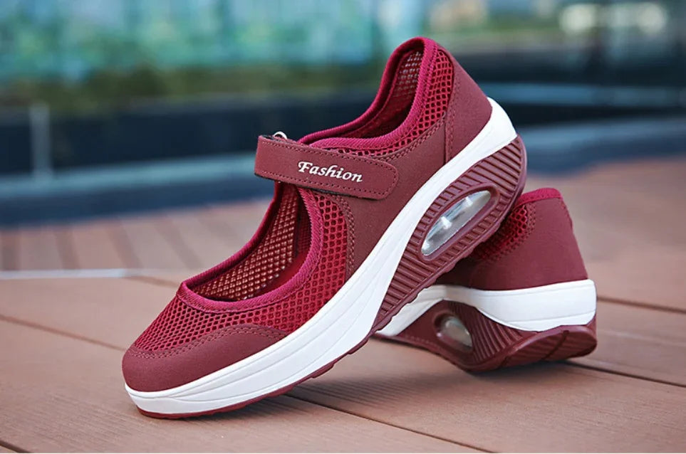 Red breathable mesh Mary Jane sneakers with cushioned white sole and air cushion heel