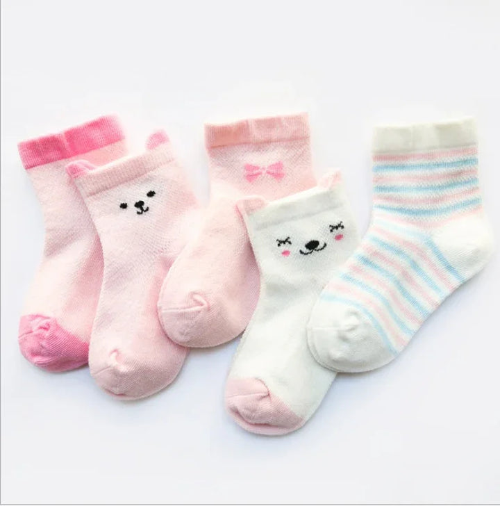 Set of five pastel baby socks with bear faces, bows, and stripes in pink, white, and blue