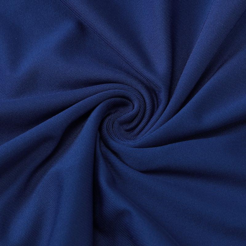 Close-up of royal blue fabric folded in a spiral pattern showing texture and weave