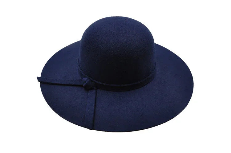 Wide brim navy blue felt hat with a simple bow detail on the band
