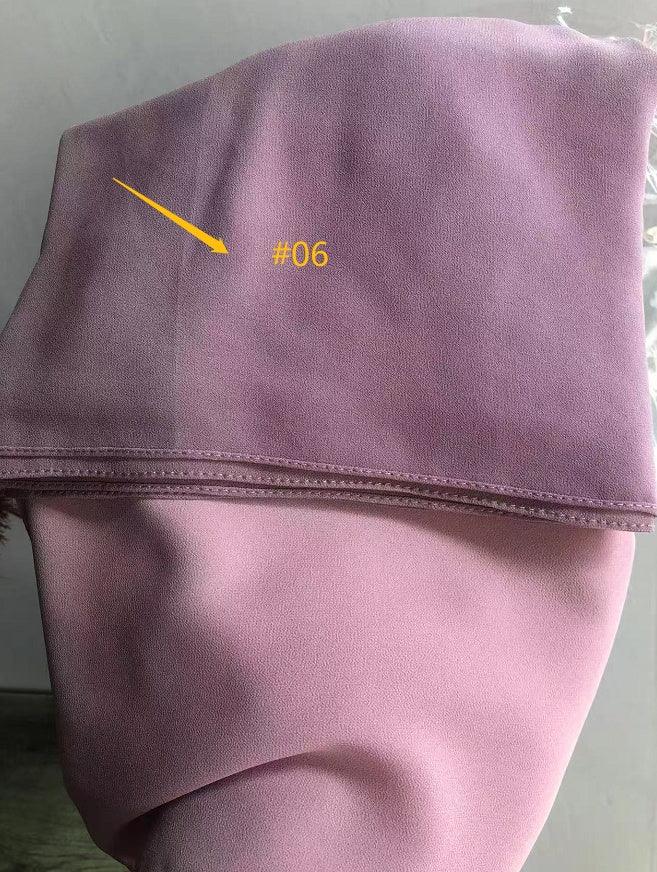 Pink fabric sample with yellow #06 label and arrow on the top section