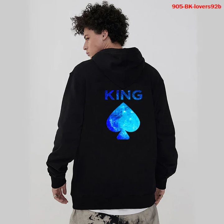 Man wearing black hoodie with blue galaxy print 'KING' text and spade symbol on back