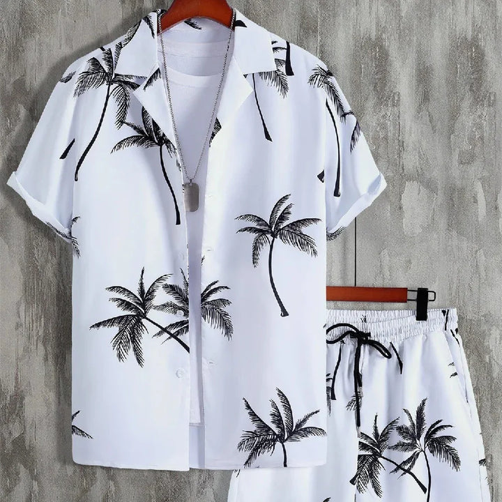 White summer outfit with black palm tree prints including short-sleeve shirt, shorts, and white inner t-shirt