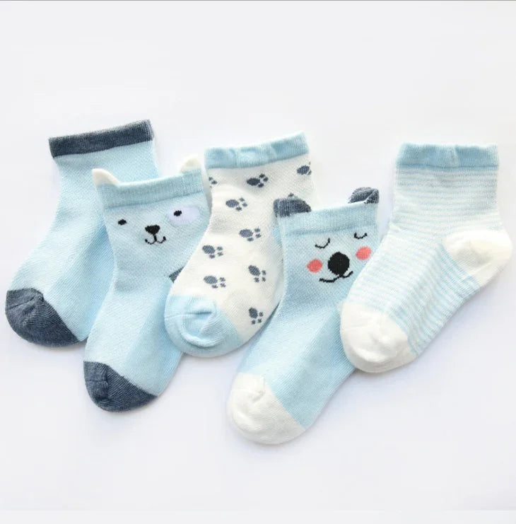 Set of five blue and white baby socks with animal faces and paw prints on a white background