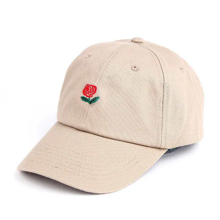 Beige baseball cap with embroidered red rose and green leaves on front panel