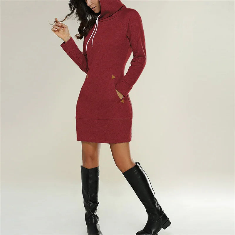 Woman wearing a casual red hoodie dress with pockets and black knee-high boots