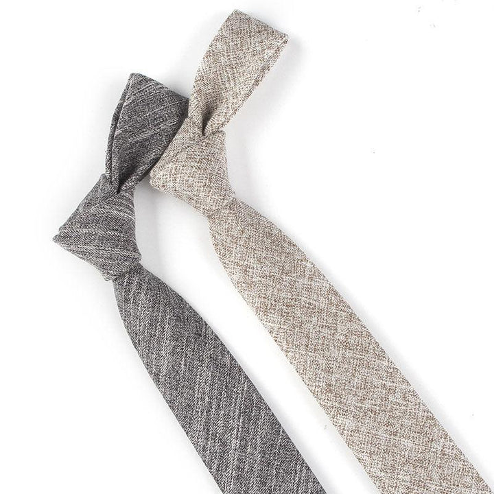 Two textured fabric neckties in gray and beige with classic knot on white background