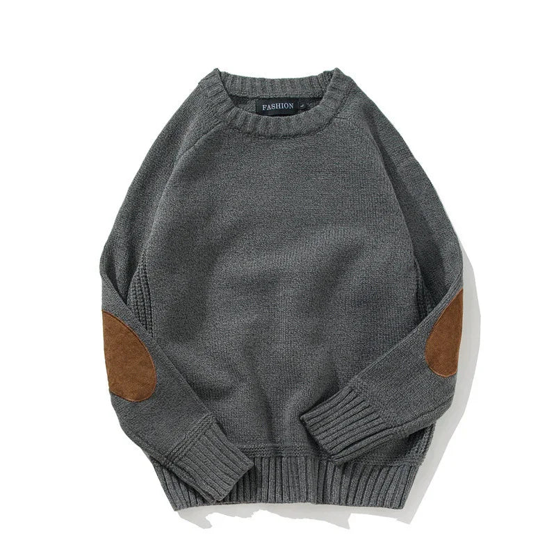 Gray knit sweater with brown suede elbow patches and ribbed cuffs and hem