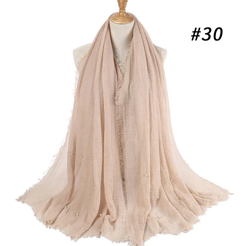 Soft beige long scarf with pearl embellishments displayed on mannequin bust