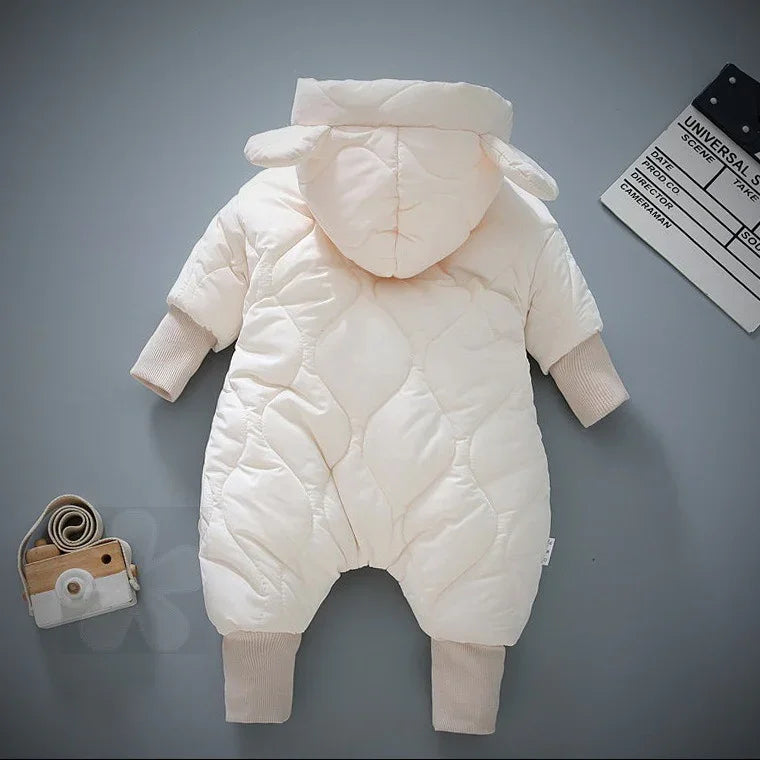 Cream-colored padded baby winter jumpsuit with hood and ribbed cuffs on gray background