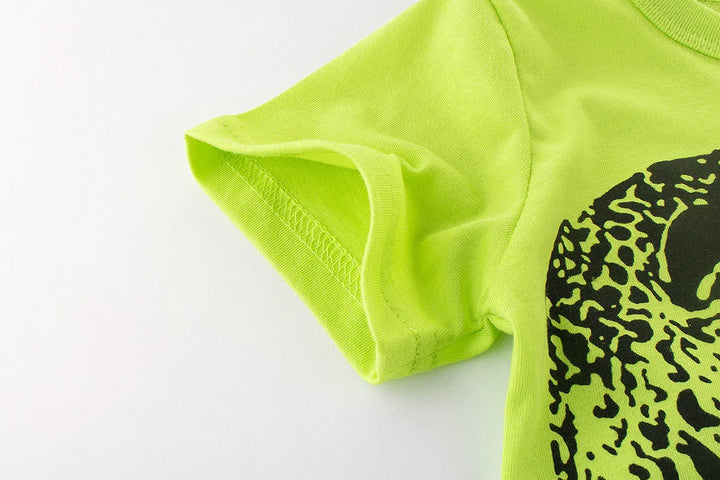 Close-up of neon green t-shirt sleeve with black leopard print graphic on white background