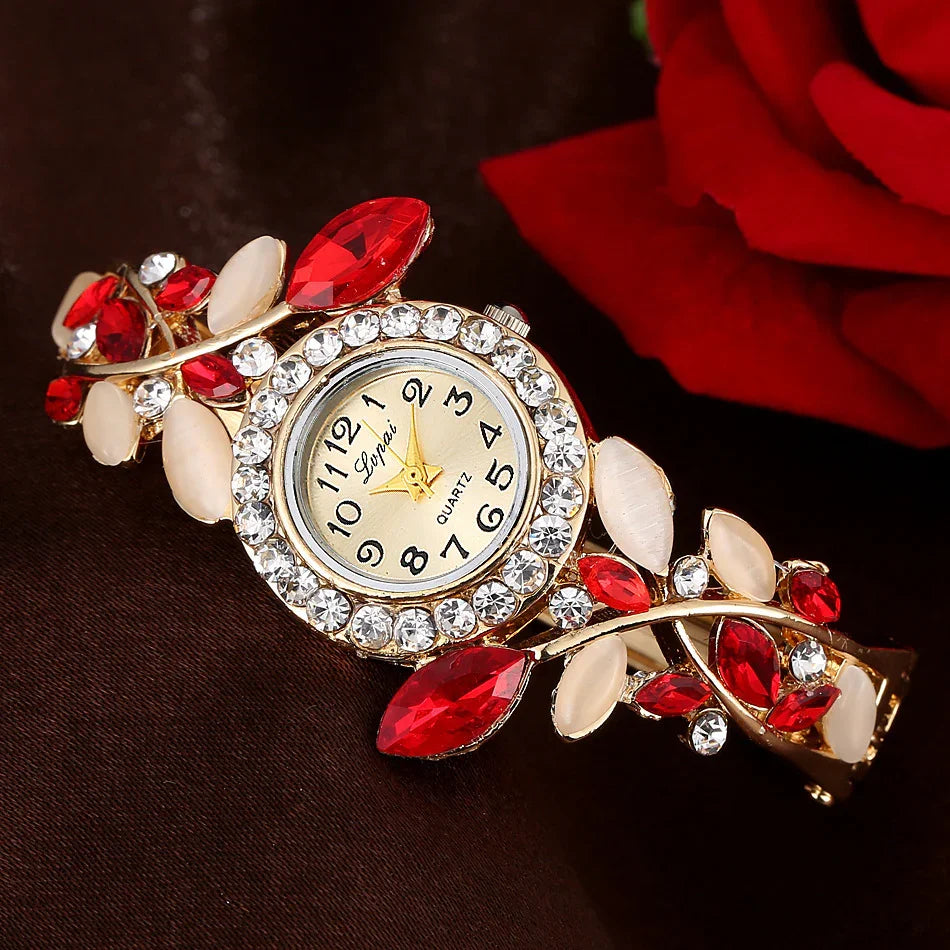 Elegant women's wristwatch with red and white gemstone bracelet on dark background with red rose