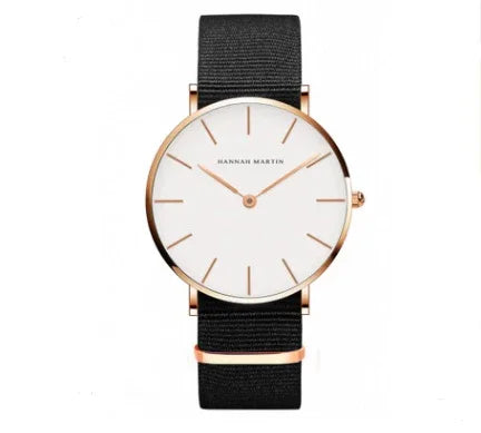 Minimalist Hannah Martin wristwatch with white dial, rose gold case, and black fabric strap