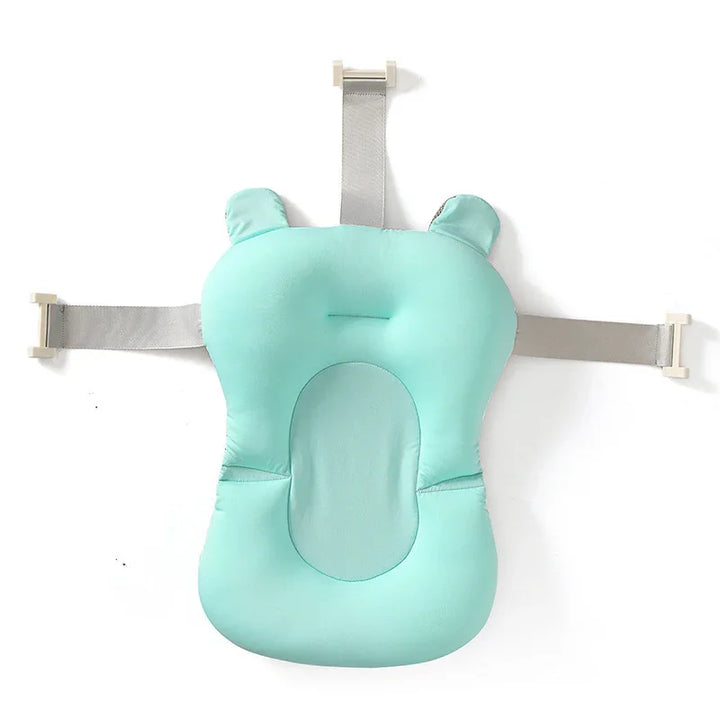 Mint green baby bath support pillow with adjustable gray straps, shaped like a teddy bear