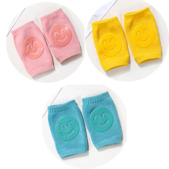 Set of colorful knee pads in pink, yellow, and blue with smiling face design
