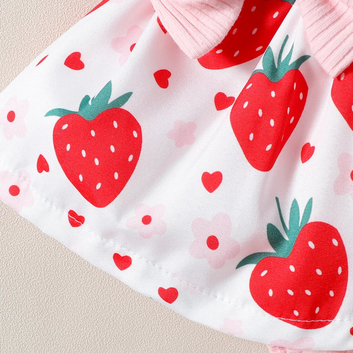 White fabric with red strawberry, pink flower, and red heart patterns and pink ribbed trim