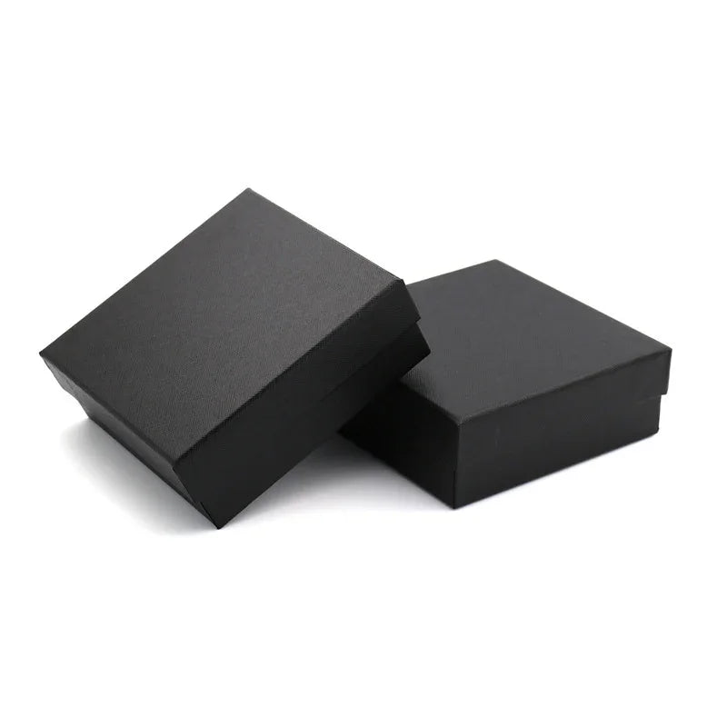Two black square gift boxes with lids on white background, minimalist packaging design