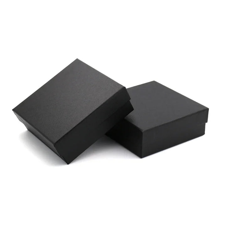 Two black square gift boxes with lids on white background, minimalist packaging design