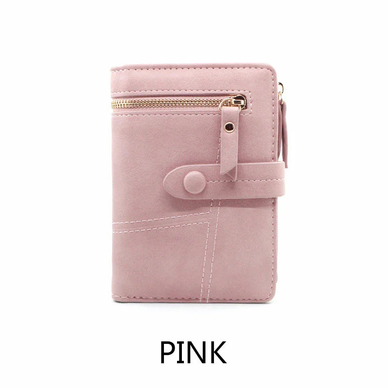 Compact pink wallet with zipper pocket and snap button closure, soft textured material