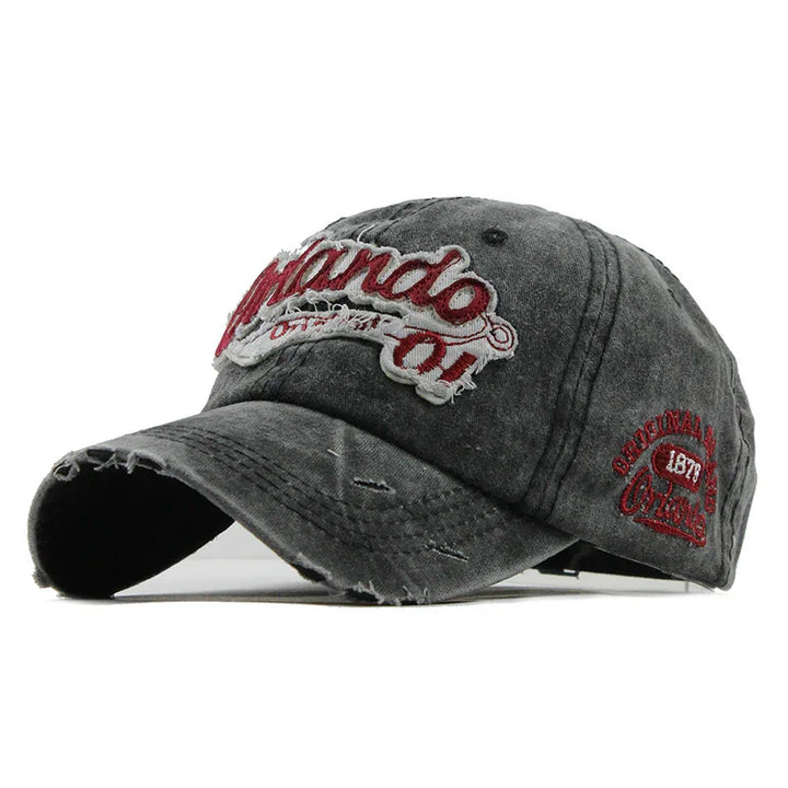 Worn black baseball cap with distressed edges and red embroidered Orlando logo and details