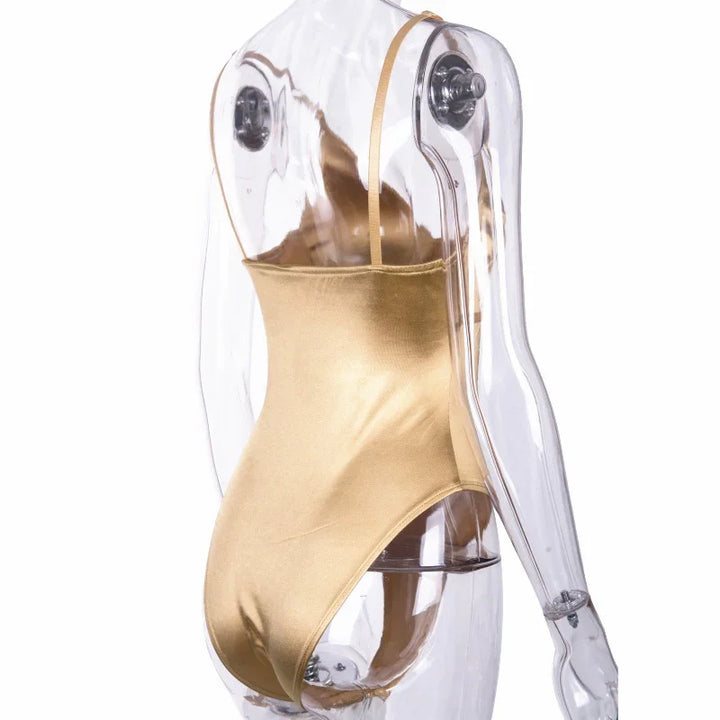 Gold one-piece swimsuit with thin straps on a transparent mannequin side view