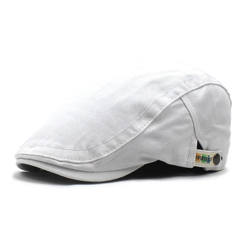 Light grey flat cap made of cotton fabric with a small colored tag detail on the side