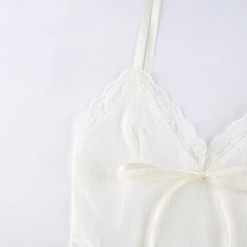 Close-up of white ribbed camisole with lace trim and bow detail on spaghetti straps