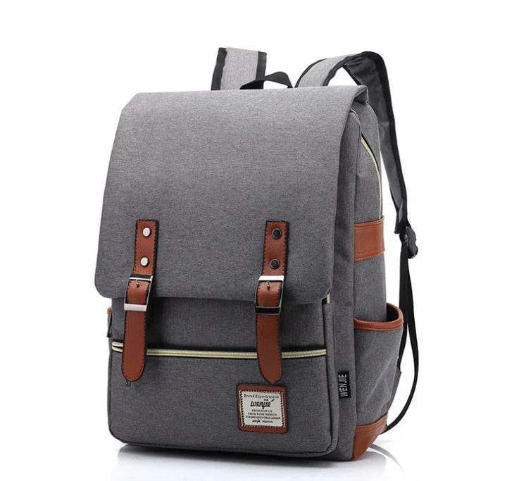 Gray canvas backpack with brown leather straps and front zip pocket, modern casual design