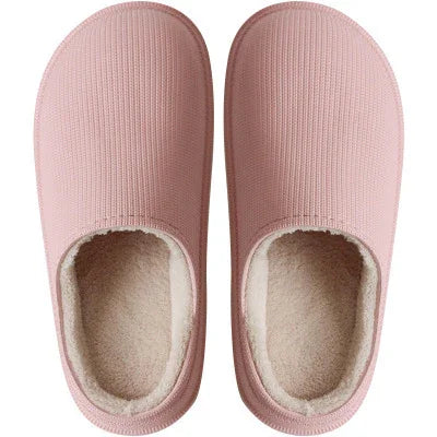 Pair of pink cozy indoor slippers with soft beige fleece lining