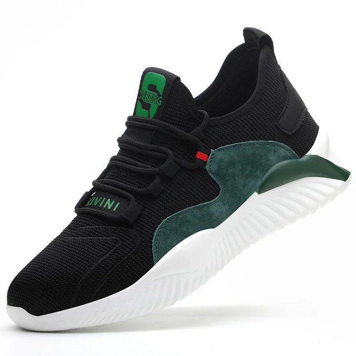 Black athletic sneaker with green suede accents, white sole, and green logo on tongue