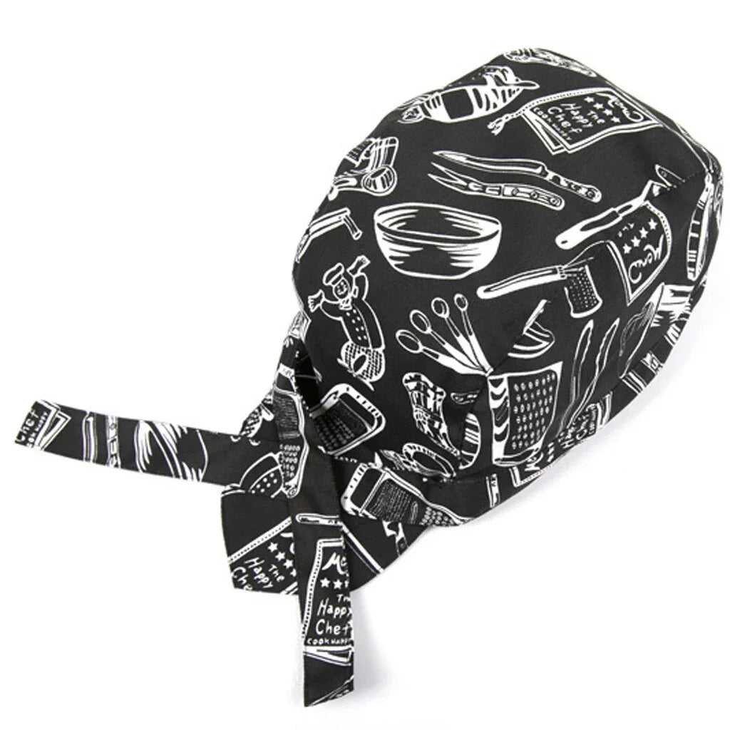 Black chef bandana with white kitchen utensils print including graters, bowls, and measuring spoons