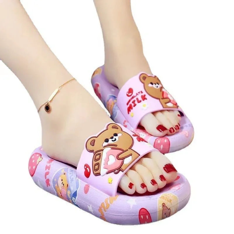 Cute purple slippers with cartoon bear and milk design, worn with red nail polish