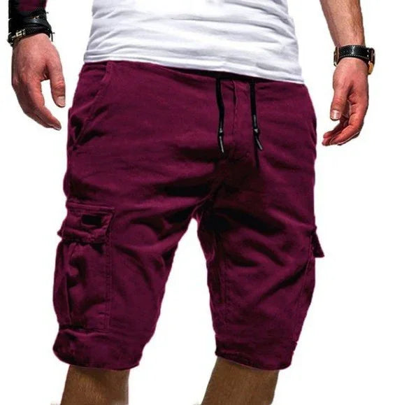 Man wearing casual purple cargo shorts with drawstring and side pockets, paired with a white t-shirt